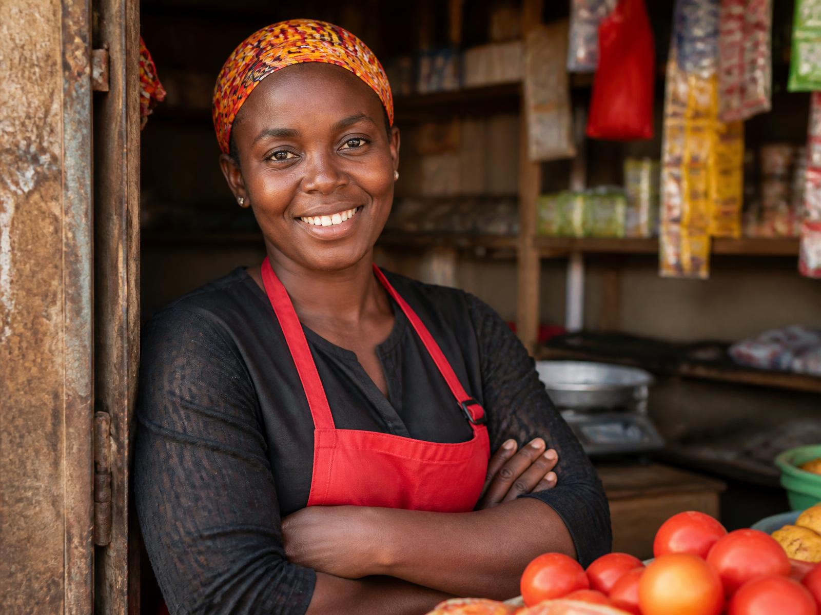 Business owner standing proudly at her market shop